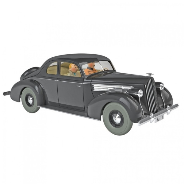 A 1/24 resin model of a dark grey 1938 Packard coupé with whitewall tyres, a chrome grille and the number plate A-11, King Muskar XII in an orange tunic at the wheel and Tintin beside him