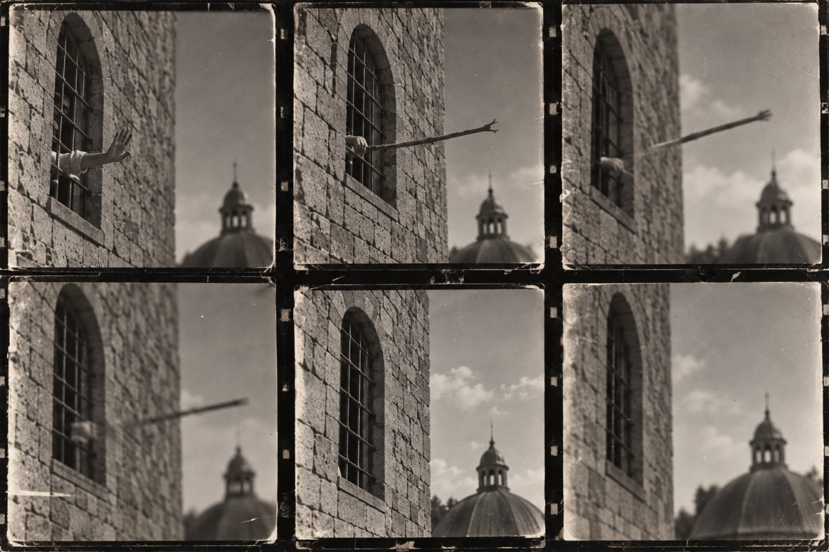 Contact sheet of six black-and-white frames taken at a barred window in the stone wall of the keep, a domed lantern roof beyond: a hand reaches out through the bars, then a forked stick is held out and thrown, flying clear of the wall