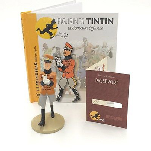 A painted resin figurine of King Muskar XII in an orange tunic with black frogging, grey breeches and black boots, drawing on white gloves, standing before its booklet, Figurines Tintin, La Collection Officielle, no. 20, Le Roi Muskar enfile ses gants, and a numbered Passeport card