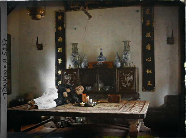 Autochrome of man reclining at opium den in Hanoi Tonkin